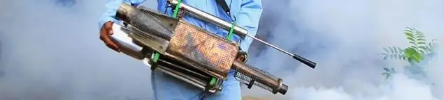 Fumigation technician using a fogger for deep pest treatment in Huntsville, AL